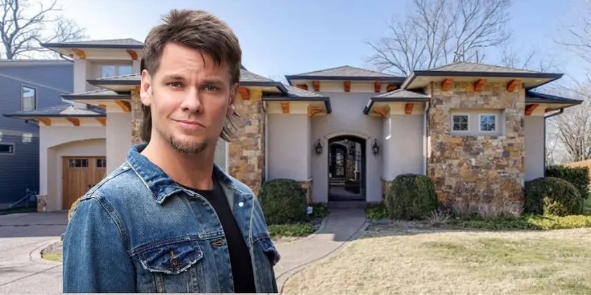 Theo Von house Nashville exterior featuring stucco and natural stone facade with arched entryway