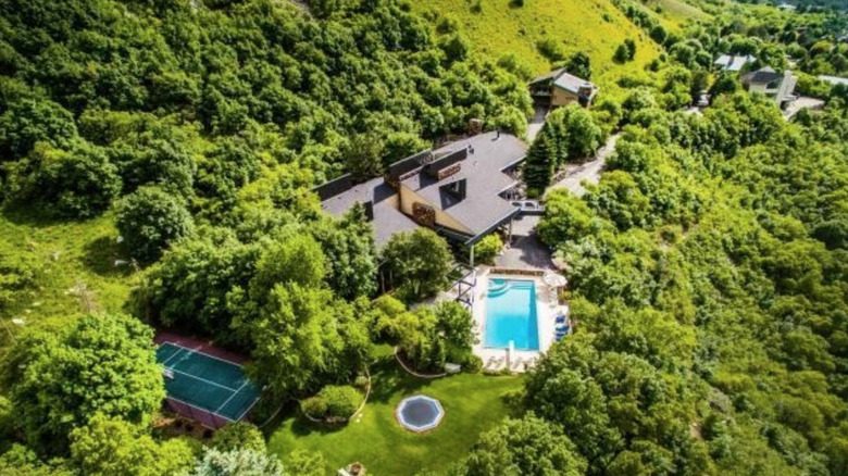 Aerial photograph showing Post Malone's Utah property with pool and tennis court surrounded by natural landscape