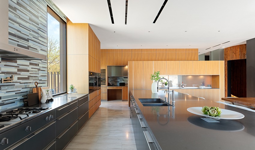 Jo Koy's Las Vegas mansion chef kitchen with modern design, luxury home features, sleek countertops, and wood cabinetry.