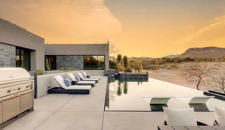 Jo Koy's Las Vegas mansion infinity pool at The Ridges Summerlin, outdoor living space with lounge chairs and grill.