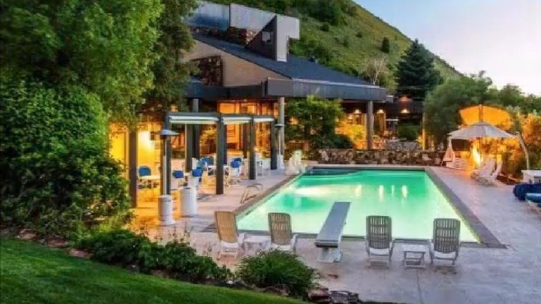 Pool lounge area with comfortable seating and mountain views