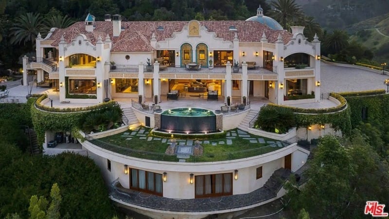 Aerial view of Travis Kelce's grand Mediterranean-style mansion with red-tiled roof, arched windows, and central courtyard