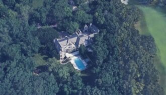 Aerial view of Travis Kelce's large Leawood mansion surrounded by dense trees with a swimming pool