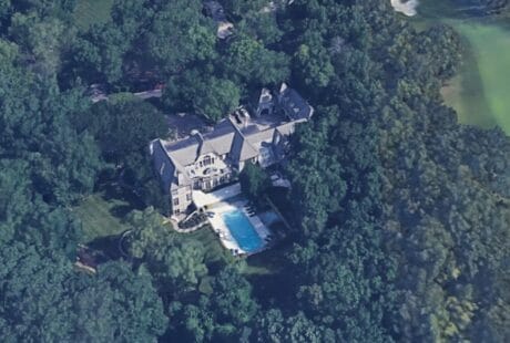 Aerial view of Travis Kelce's large Leawood mansion surrounded by dense trees with a swimming pool