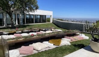 Modern outdoor patio at Jay Shetty home with minimalist white architecture and city skyline view