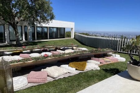 Modern outdoor patio at Jay Shetty home with minimalist white architecture and city skyline view