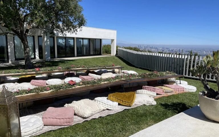 Modern outdoor patio at Jay Shetty home with minimalist white architecture and city skyline view