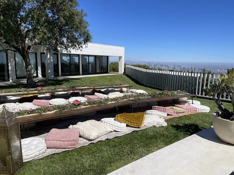 Modern outdoor patio at Jay Shetty home with minimalist white architecture and city skyline view