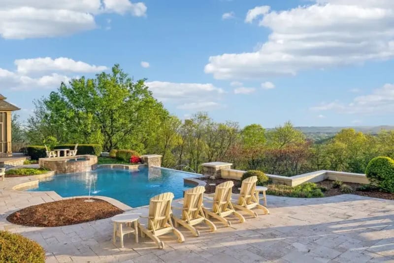 Outdoor pool and patio area at Dave Ramsey former hilltop estate in Franklin Tennessee with resort-style infinity pool overlooking Tennessee countryside
