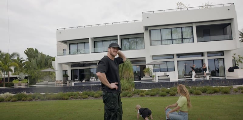 Logan Paul with his wife Nina Agdal and daughter outside their modern white mansion in Dorado Beach.