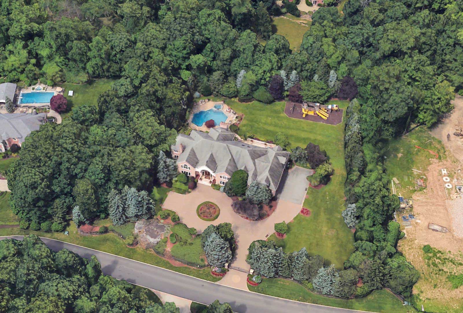 Aerial view of Chris Rock's Alpine, New Jersey estate showing the house, driveway, lawn and pool