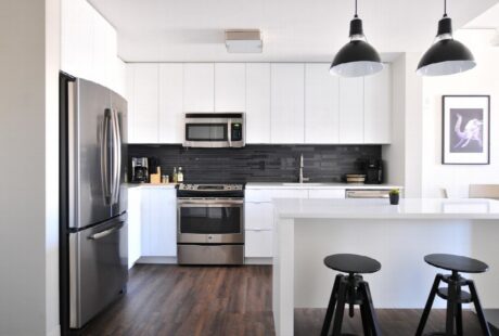 A bright luxury kitchen with island seating and carefully placed built-in appliances