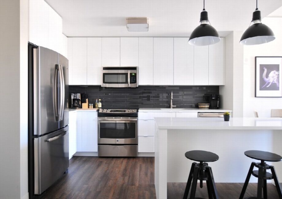 A bright luxury kitchen with island seating and carefully placed built-in appliances